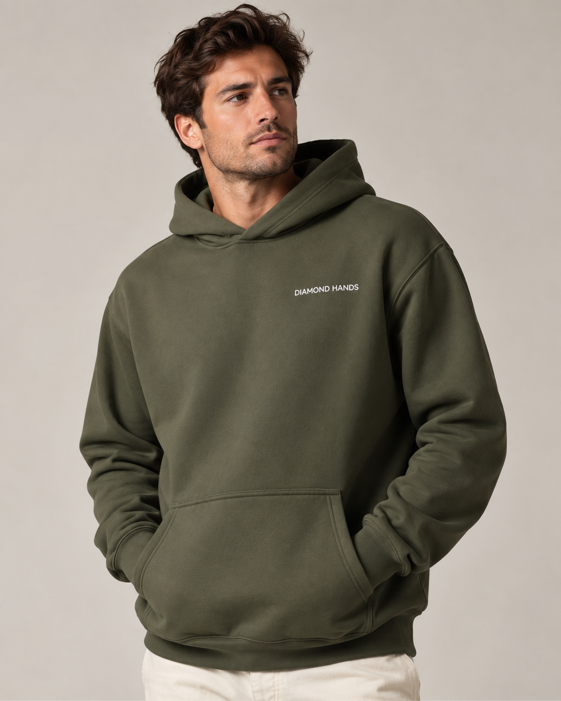 Man wearing a Cypress Diamond Hands hoodie with white left-chest embroidery, photographed in a neutral studio.
