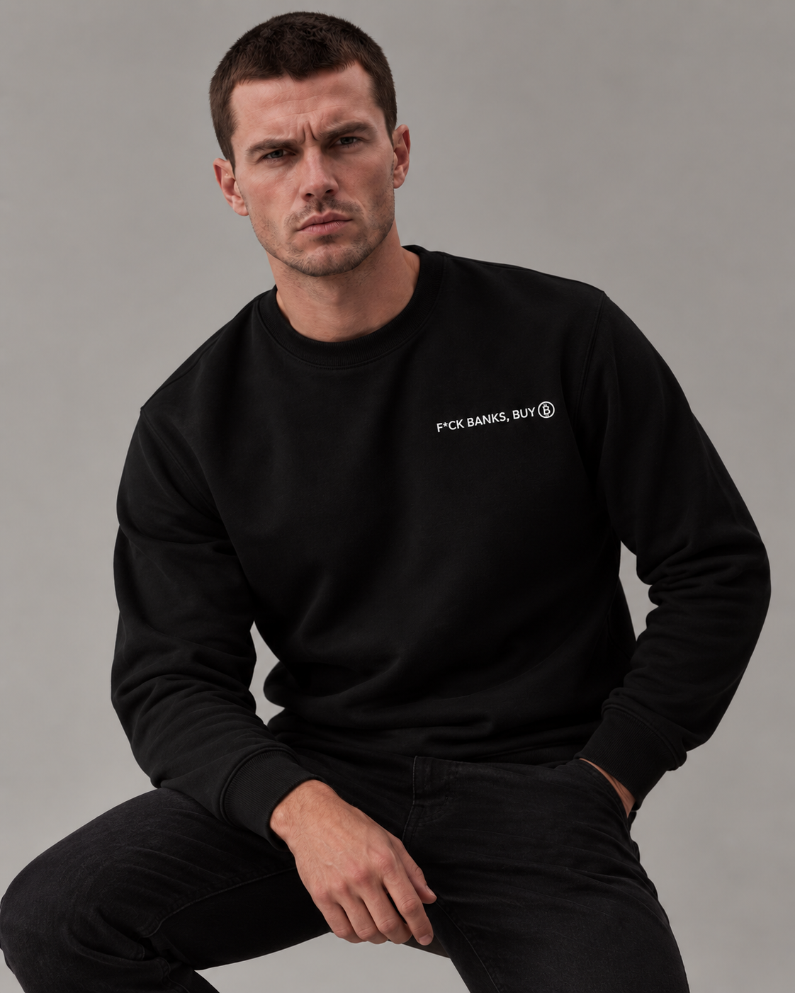 Male studio portrait wearing the Black F*ck Banks Buy Bitcoin sweatshirt with white embroidery