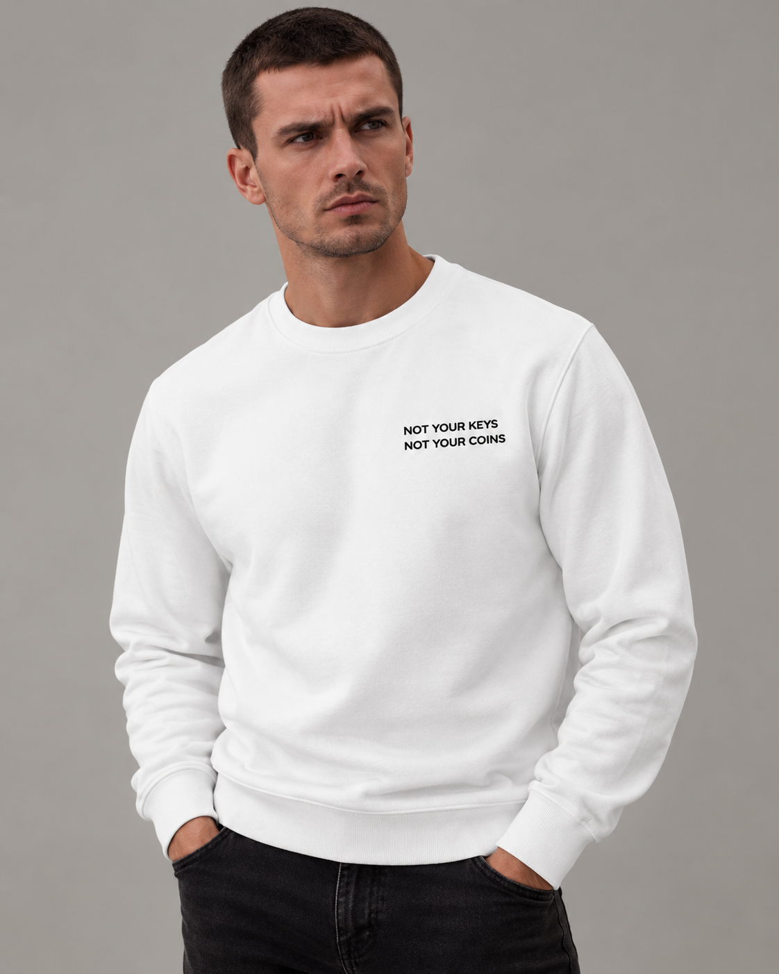 Male studio portrait wearing the White Not Your Keys Not Your Coins sweatshirt with black embroidery