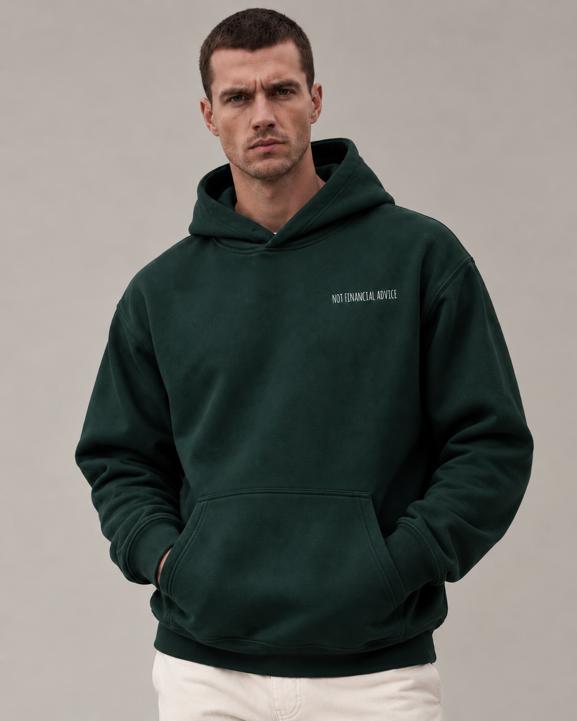 Male model wearing the Pine Green Not Financial Advice embroidered hoodie against a neutral studio background